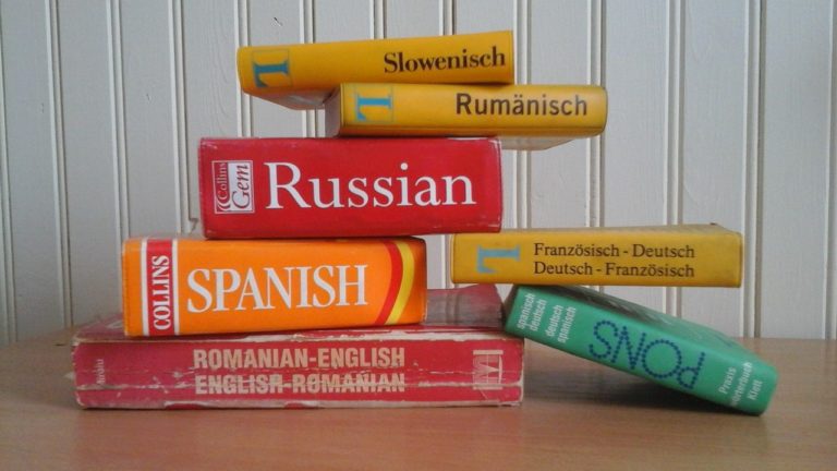 a stack of books to learn different languages