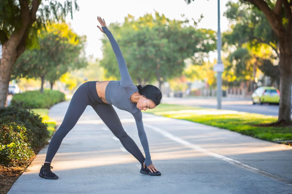 woman in comfortable clothing stretching before working out or dancing